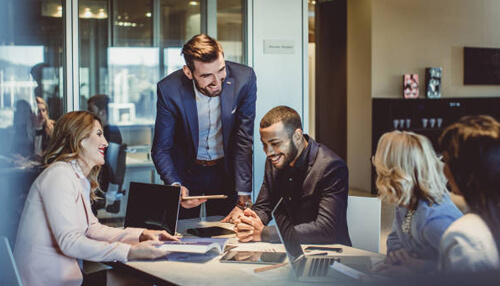 Keep communication lines open between staff Group of business professionals in a meeting, representing discussions around managing employee time theft and productivity.