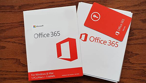 Microsoft office 365 Two office 365 product boxes and a red office 365 key card placed on a wooden surface, representing microsoft office 365 software packages.
