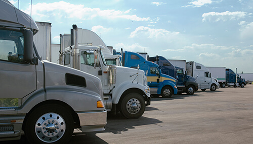 Types of semi trucks - tycoonstory | tycoonstory media A line of parked semi-trucks, representing fleet vehicles that could benefit from comprehensive coverage under liberty mutual car insurance.