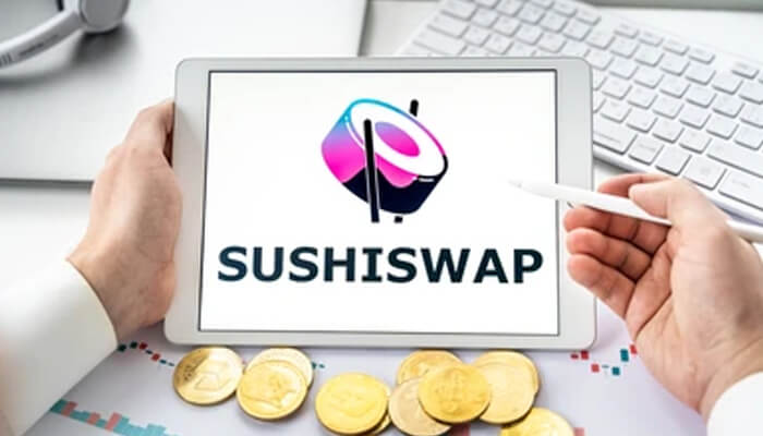 Sushiswap Person holding a tablet displaying the sushiswap logo, with coins representing cryptocurrency investments.