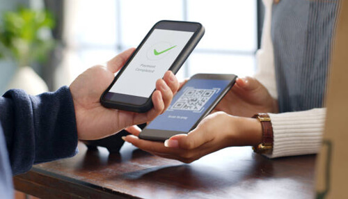 What is a payment link A person completing a mobile payment by scanning a qr code, demonstrating the convenience of using payment links for digital transactions