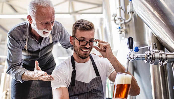Teach the foundations A family working together in a brewery, showcasing the bond and collaboration that define many successful family businesses.