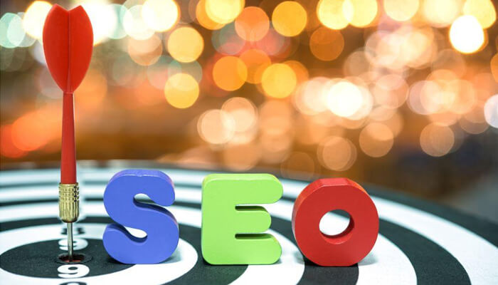 Seo Seo target: the word'SEO' spelled out in colorful letters on a dartboard, symbolizing hitting the target in SEO goals and outsourcing SEO services to achieve success.