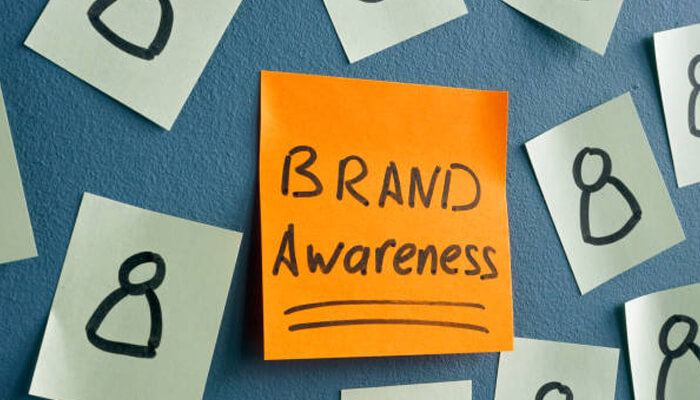 Helps to boost your brand awareness Sticky note with “brand awareness” written on it, symbolizing how digital marketing helps the oil and gas industry improve brand visibility.
