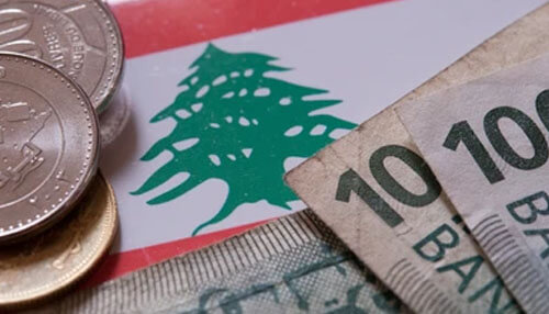 Lebanese banks Lebanese currency and coins placed over the lebanese flag, illustrating financial topics often discussed in analyses involving marwan kheireddine.