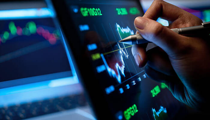 Not suitable for short-term investments - tycoonstory | tycoonstory media Hand using a stylus on a tablet to analyze market trends, including data related to index funds and stock investments.