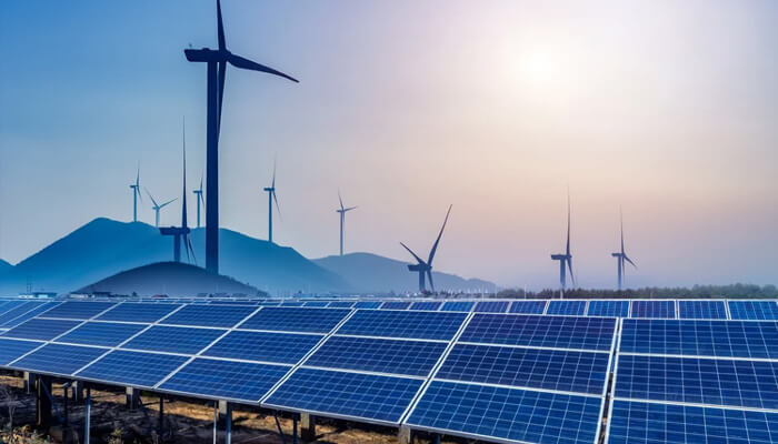 Renewal energy sector in the year 2022 Solar panels in the foreground with wind turbines in the background, highlighting the synergy of solar and wind energy in sustainable power generation.