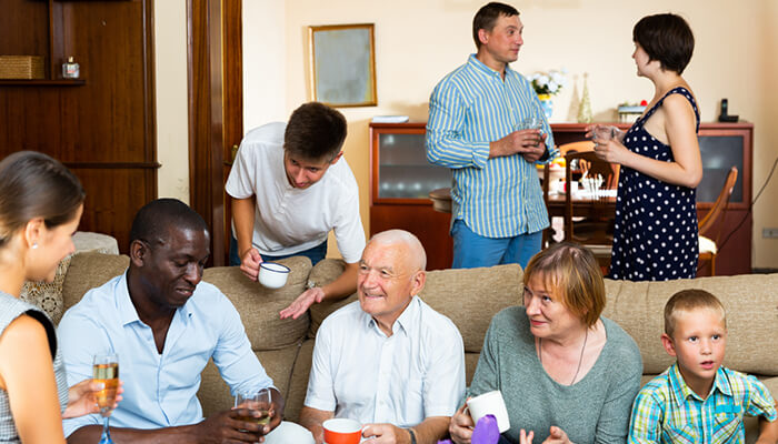 Have family meetings A joyful family gathering, emphasizing the strong relationships and shared values that often drive family businesses to success.