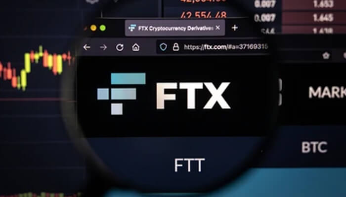 Ftx The orange and white coindesk logo on a mobile phone screen, with the background showing a web browser displaying content, likely related to the crypto industry or the ftx exchange.