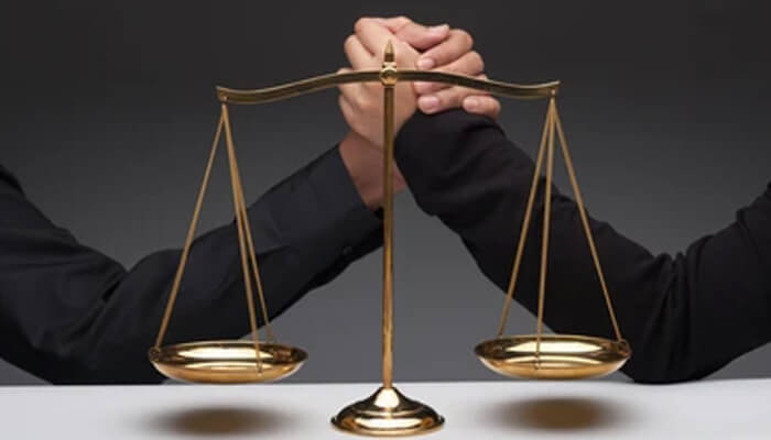 Google entering the legal fight with india’s antitrust verdict Two individuals arm-wrestling behind a golden balance scale, symbolizing legal conflict, justice, or dispute resolution related to the supreme court.