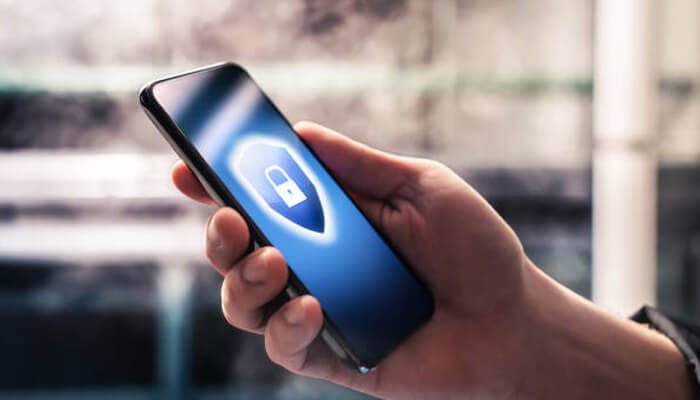 Mobile security threats Close-up of a hand holding a smartphone displaying a lock symbol, highlighting business mobile security and data protection.