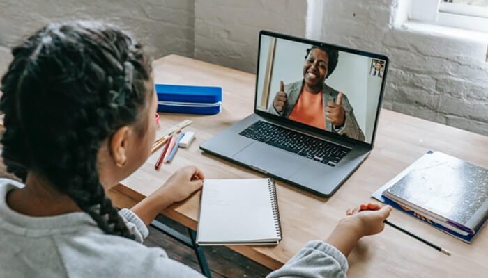 Home businesses online teaching Student attending an online class on a laptop, highlighting remote learning and virtual collaboration environments.