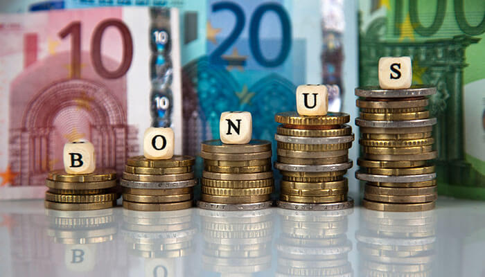 Benefits of bonus shares Stacks of coins with letter blocks spelling bonus against euro banknotes, illustrating growth in investments through bonus shares.