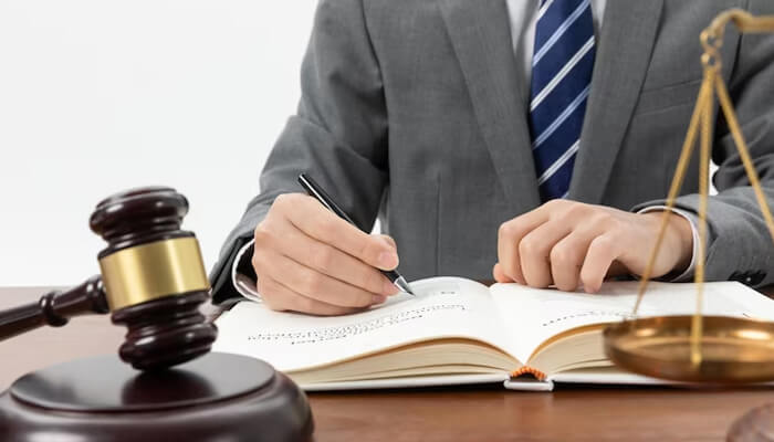 Cooperate with your lawyer and provide them with all the necessary information Lawyer reviewing legal documents and preparing a personal injury settlement case, highlighting the importance of expert legal representation.