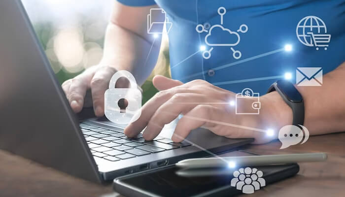 Do not respond to unknown sms, calls, or emails Person using a laptop with security icons displayed, representing measures to prevent fraudsters from accessing personal data.