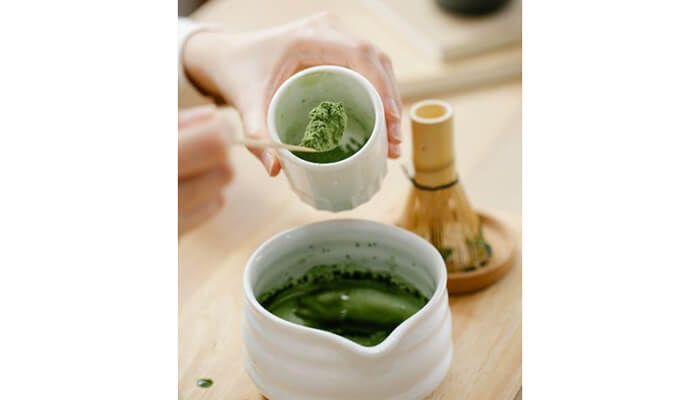 It is one of the most potent shots Green matcha mixture being poured into a cup, illustrating daily preparation rituals connected to mit45.