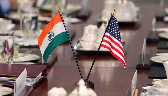 The negotiations detials Us and india flags displayed on a table, representing the growing collaboration between the two nations in diplomacy and defense.