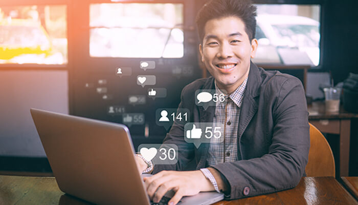 Businesses Entrepreneur using a laptop with social engagement metrics, representing modern businesses building an online presence.