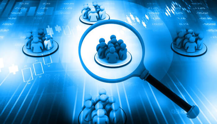 Thorough research on the audience Illustration of buyer personas under a magnifying glass, symbolizing the process of analyzing and identifying target customer groups.