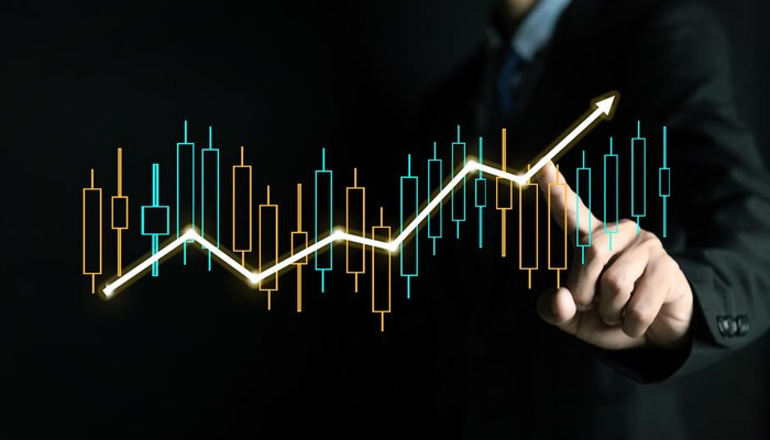 Why should you think about studying actuarial science Image of a professional analyzing a rising stock chart with digital graphs, representing the role of actuaries in financial analysis and actuarial jobs.