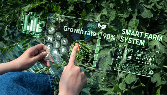 Benefits of iot in precision agriculture - tycoonstory | tycoonstory media Smart farm system interface displaying crop growth rate, soil metrics, and sensor data over plants, representing advanced agricultural monitoring technology.