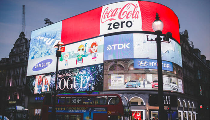 Brand awareness and advertisement Large digital billboard advertisements in city center featuring global brands and illuminated marketing displays.