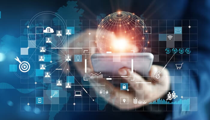 Digital technologies A person holding a smartphone surrounded by a blue digital overlay showing a glowing global network. Various icons related to business, data, e-commerce, and user profiles are interconnected, representing data analysis and technology used to implement a comprehensive customer retention strategy.