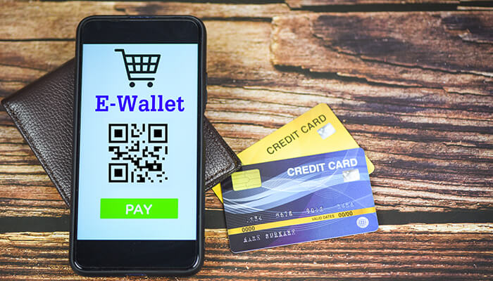 E-wallets Payment methods on gambling sites: a smartphone shows an "e-wallet" screen with a qr code beside two credit cards.