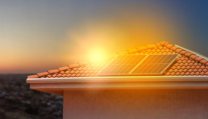 Is it worth the expense of incorporating solar energy into our daily lives Solar panel installed on a rooftop during sunset, harnessing solar energy for clean, renewable electricity.