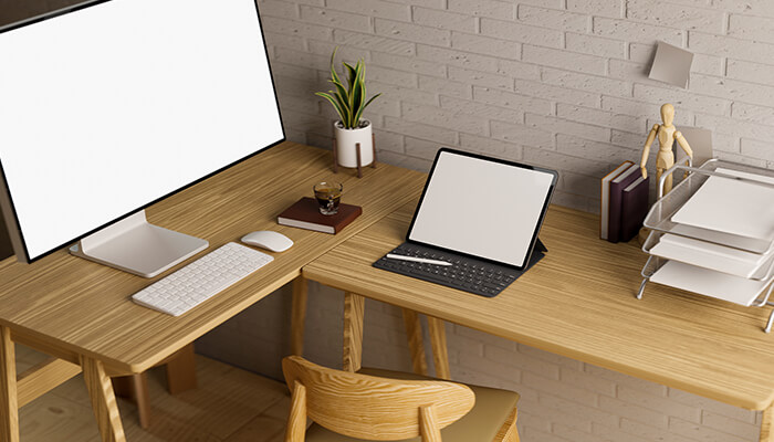 L shaped desk Shaped desks used in a minimalist home office setup with dual screens and organized accessories, highlighting space-efficient and ergonomic design.