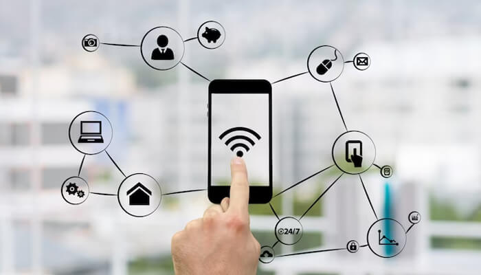 Cell phone signal booster for outdoor enthusiasts A hand interacting with a smartphone on a digital interface, illustrating how a cell phone signal booster improves connectivity in a networked environment.
