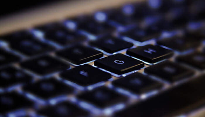 What is live online playing Close-up shot of a computer keyboard, with emphasis on the illuminated'G' key, symbolizing technology and interaction in the world of live casinos.