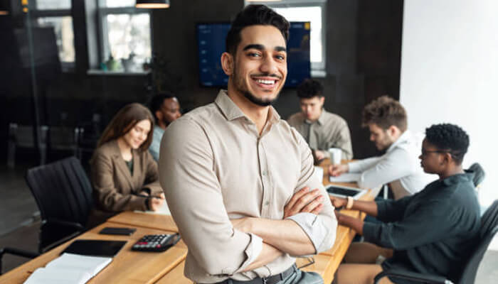 List of in-demand occupations and jobs in emigration Young professional working abroad in a modern office with a multicultural business team