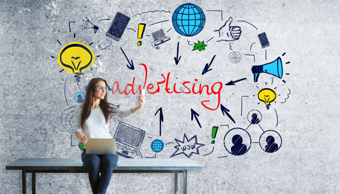 Return on marketing investments Woman using a laptop with advertising graphics, focusing on strategies to improve return on marketing investments.