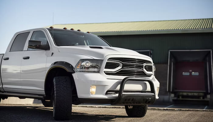 Change the wheels and tires White ram truck with off-road styling features, perfect for anyone considering how to upgrade your jeep gladiator for a more aggressive look and performance.