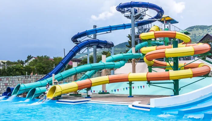 The dos and don'ts of Choosing a Water Slide for Your Commercial Space A thrilling water slide featuring multi-colored tubes and a pool below, providing an adventurous and fun-filled water slide experience at the water park.