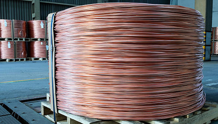 Copper prices decline due to weak chinese demand Large coil of copper wire, showcasing copper materials, with an indirect reference to fluctuating copper prices