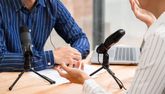 Did joe rogan really believe tom delonge's confessions Two individuals recording a podcast interview with mics and laptop setup, resembling a discussion format seen on the joe rogan podcast.