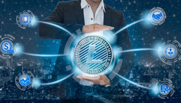 Litecoin-tycoonstory | tycoonstory media Businessman holding a digital litecoin symbol surrounded by fintech icons, highlighting crypto innovation in the crypto casino market.
