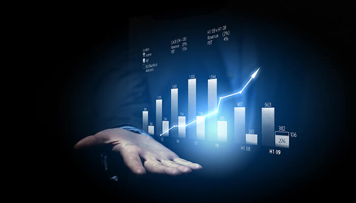 No-growth-tycoonstory | tycoonstory media Hand holding a digital graph with bars and a rising trend line, symbolizing business growth and performance analytics.