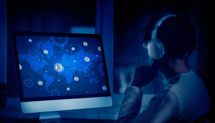 What are crypto custody services Person wearing headphones in front of a computer screen displaying a global cryptocurrency network interface.