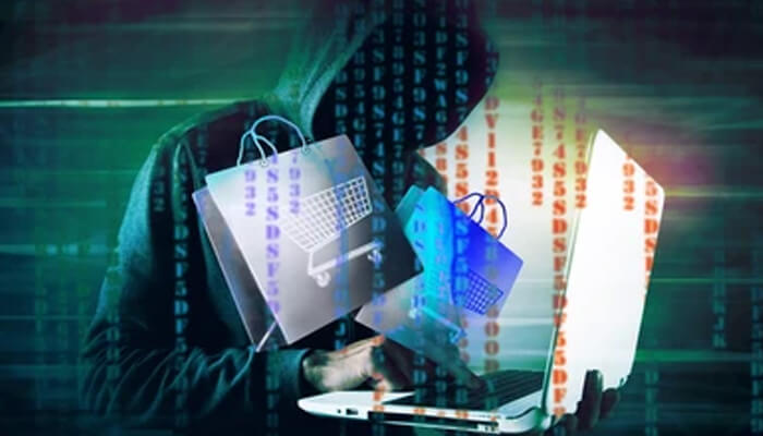 How are brushing scams carried out A hooded figure typing on a laptop with overlaid shopping bag icons and digital code, representing cybersecurity risks when shopping on major retailers like amazon.