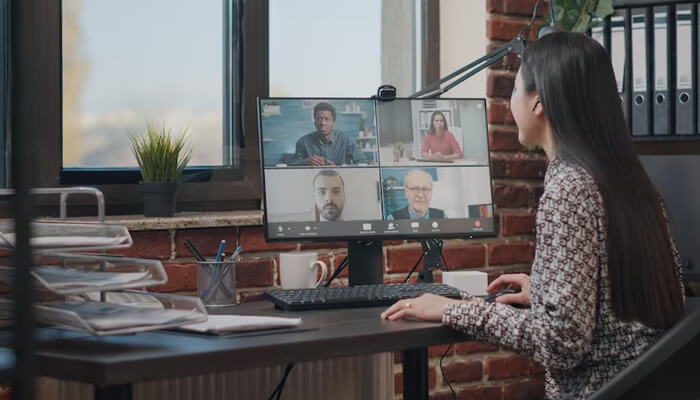 Advantages of a virtual address A person participating in a video conference on a desktop computer, representing the concept of a virtual office and remote collaboration in modern workspaces.