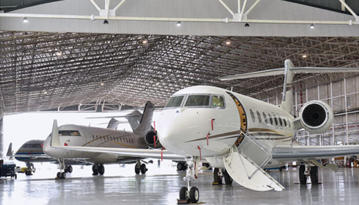 Private jet Two private jets inside a spacious hangar, representing the high-end luxury and comfort associated with private jet travel.