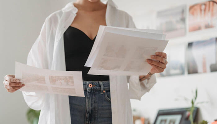 Lxp vs lms Woman holding printed images, symbolizing content management in lxp vs lms platforms for personalized learning experiences.