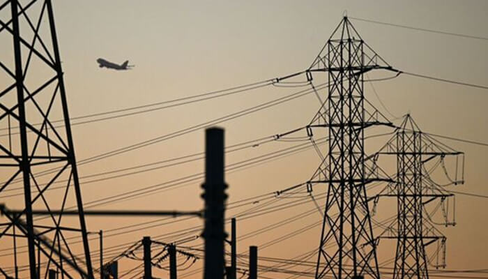 Power supplier Electricity transmission towers against a sunset sky, symbolizing the role of power suppliers in delivering energy across vast distances.