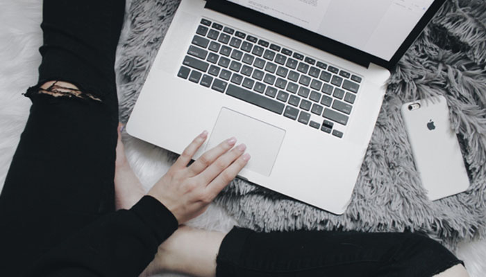 Send email newsletters A person interacting with a laptop, representing the convenience and accessibility of the online casino industry, where players can enjoy games from home.