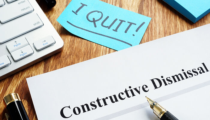 They can determine the validity of a constructive dismissal claim Office desk with resignation note and constructive dismissal document, illustrating workplace disputes and employee rights related to a constructive dismissal claim.