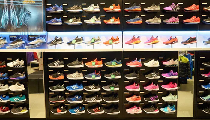 Yeezy stock Adidas shoes displayed in a store, showcasing a variety of athletic footwear in different colors and styles, highlighting the brand's range of running shoes and sportswear.