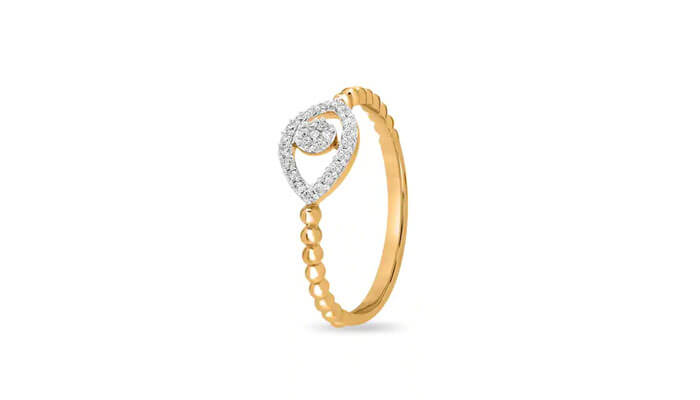 14 kt yellow gold round diamond ring - tycoonstory | tycoonstory media Delicate gold ring with a teardrop-shaped diamond accent on a beaded band, minimal and elegant.